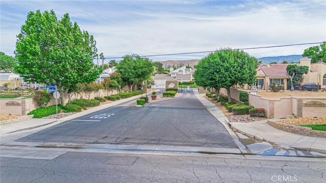 5340 Gardendale Ln, Palmdale, CA 93551 - view of asphalt street featuring sidewalks, curbs, a residential view, and traffic signs