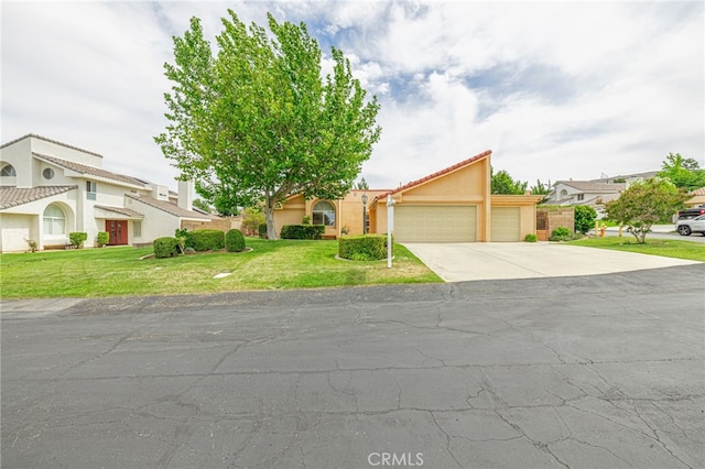5340 Gardendale Ln, Palmdale, CA 93551 - view of front facade with an attached garage, concrete driveway, a front yard, and stucco siding
