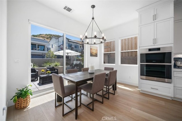 4019 Hillside Dr, San Luis Obispo, CA 93401 - dining area featuring a chandelier and light wood-type flooring