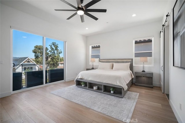 4019 Hillside Dr, San Luis Obispo, CA 93401 - bedroom with a barn door, wood finished floors, access to exterior, recessed lighting, and a ceiling fan