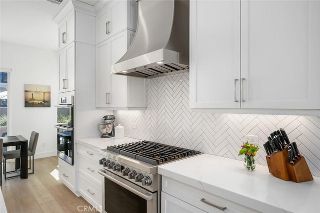 4019 Hillside Dr, San Luis Obispo, CA 93401 - kitchen with wall chimney range hood, appliances with stainless steel finishes, tasteful backsplash, white cabinets, and light stone countertops