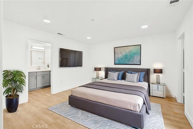 500 N Brannick Ave Unit 2, City Terrace, CA 90063 - bedroom featuring light wood-style flooring, recessed lighting, ensuite bathroom, and baseboards
