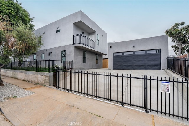 500 N Brannick Ave Unit 2, City Terrace, CA 90063 - contemporary home featuring a fenced front yard, stucco siding, a balcony, and driveway