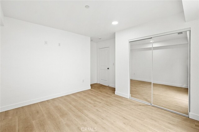 500 N Brannick Ave Unit 2, City Terrace, CA 90063 - unfurnished bedroom with light wood-style floors, a closet, recessed lighting, and baseboards