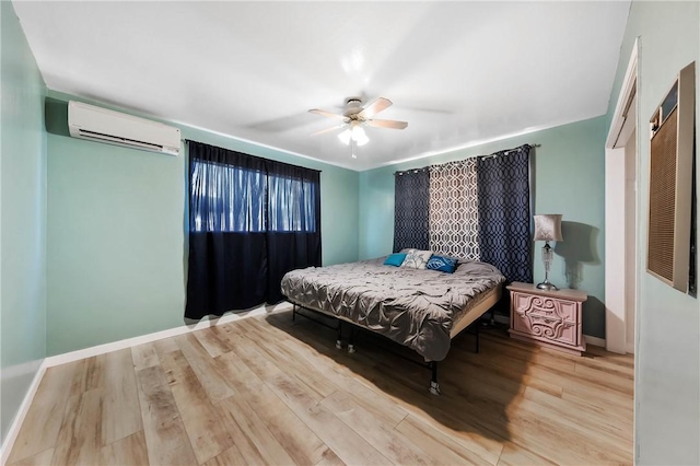 3206 4th St, Clearlake, CA 95422 - bedroom featuring a wall mounted air conditioner, wood finished floors, baseboards, and a ceiling fan