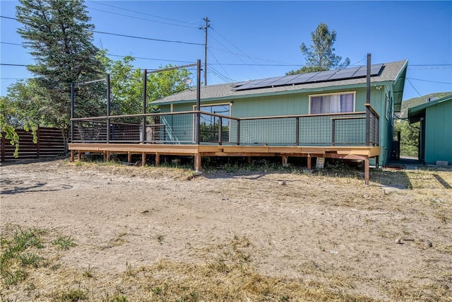3206 4th St, Clearlake, CA 95422 - rear view of property with solar panels, a wooden deck, and a shingled roof