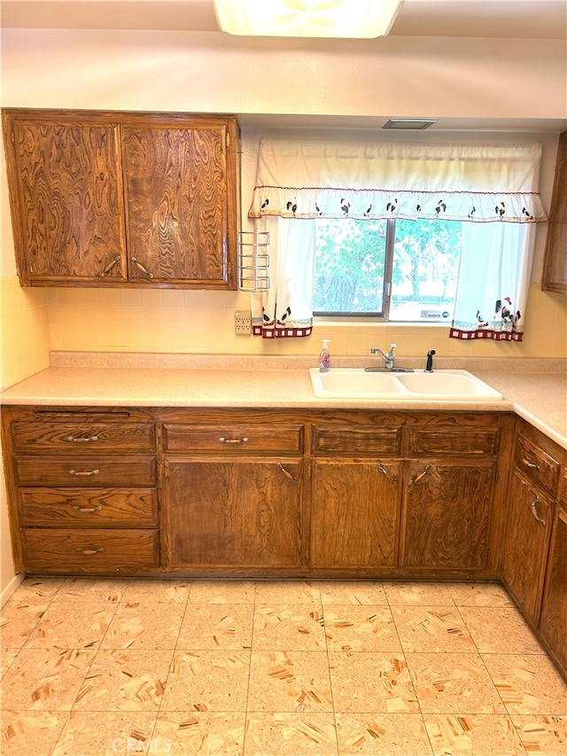 28711 Del Monte Dr, Menifee, CA 92586 - kitchen featuring a sink, light countertops, and backsplash