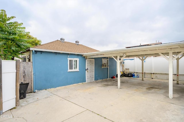 5621 Carlota Blvd, Los Angeles, CA 90042 - back of house with stucco siding, a carport, and a shingled roof