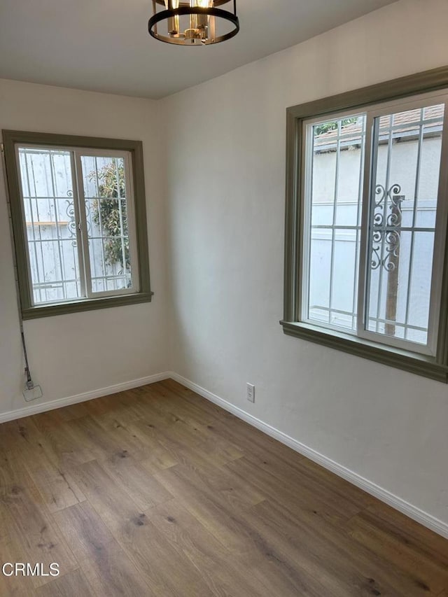5621 Carlota Blvd, Los Angeles, CA 90042 - spare room featuring a chandelier, wood finished floors, and baseboards