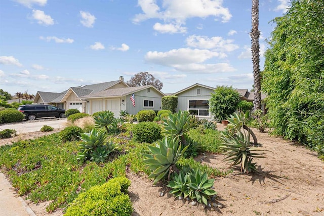 2745 La Gran Via, Carlsbad, CA 92009 - view of front facade featuring a garage, board and batten siding, and driveway