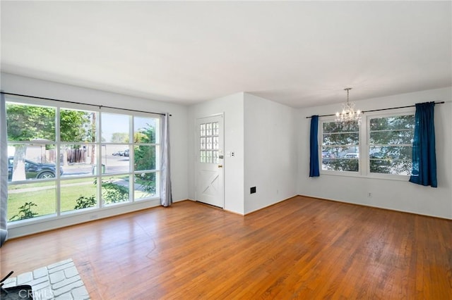 1714 N Towner St, Santa Ana, CA 92706 - unfurnished living room with a chandelier and wood finished floors