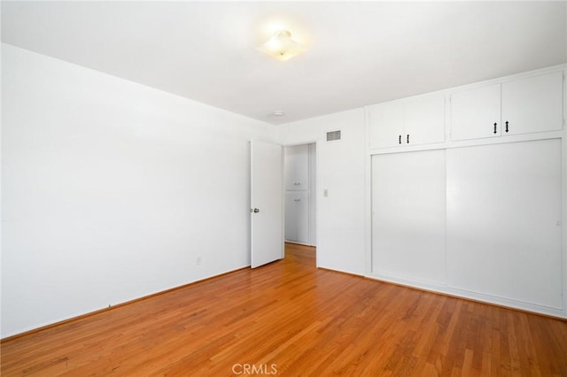 1714 N Towner St, Santa Ana, CA 92706 - unfurnished bedroom with light wood-style floors and a closet