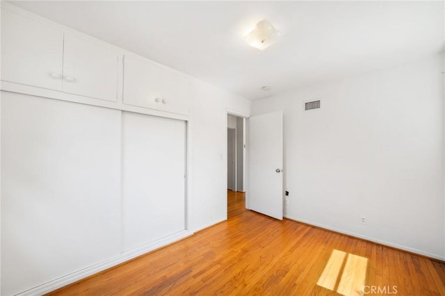 1714 N Towner St, Santa Ana, CA 92706 - unfurnished bedroom with a closet, light wood-style flooring, and baseboards