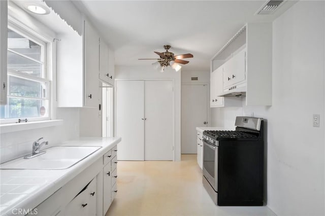 1714 N Towner St, Santa Ana, CA 92706 - kitchen featuring stainless steel range with gas stovetop, under cabinet range hood, a sink, tile countertops, and a ceiling fan