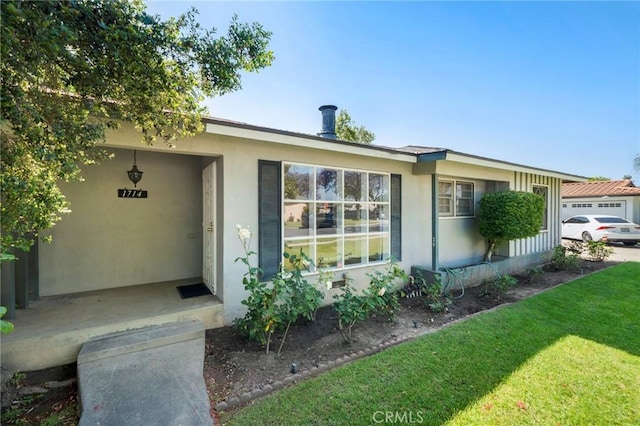 1714 N Towner St, Santa Ana, CA 92706 - view of front of property featuring stucco siding and a front lawn