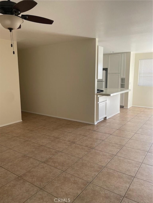 7078 Sheridan Ave Unit 29, Palms, CA 92277 - unfurnished living room featuring light tile patterned floors, ceiling fan, and baseboards