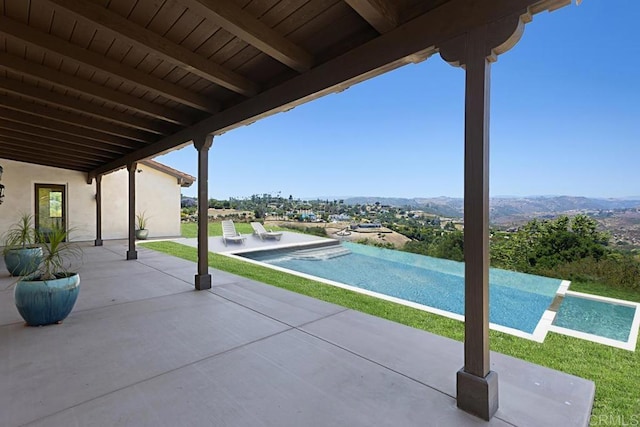1010 Willowcreek Ln, Fallbrook, CA 92028 - view of patio / terrace with an infinity pool and a mountain view