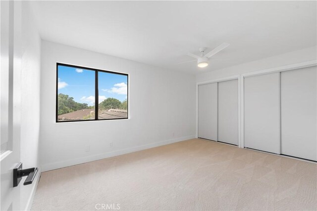 42346 W 47th St W, Lancaster, CA 93536 - unfurnished bedroom featuring two closets, light carpet, baseboards, and a ceiling fan