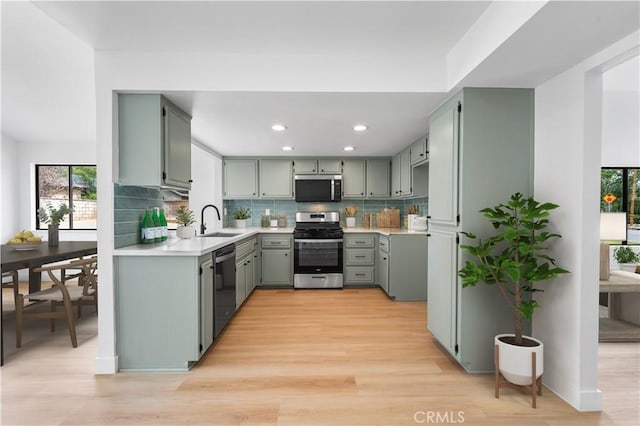 42346 W 47th St W, Lancaster, CA 93536 - kitchen featuring appliances with stainless steel finishes, decorative backsplash, light countertops, light wood-style floors, and recessed lighting