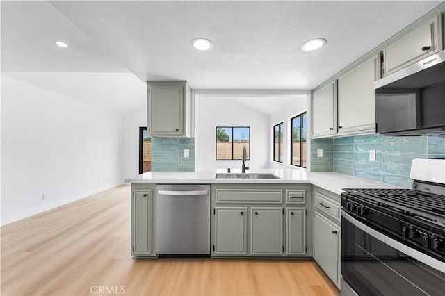 42346 W 47th St W, Lancaster, CA 93536 - kitchen with stainless steel appliances, a sink, lofted ceiling, gray cabinets, and light wood finished floors