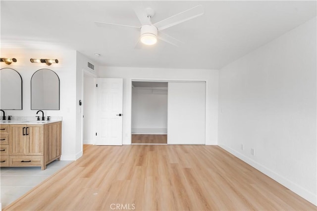 42346 W 47th St W, Lancaster, CA 93536 - unfurnished bedroom featuring baseboards, light wood-style floors, a closet, a sink, and a ceiling fan