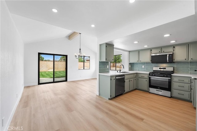 42346 W 47th St W, Lancaster, CA 93536 - kitchen featuring appliances with stainless steel finishes, gray cabinetry, backsplash, light countertops, and vaulted ceiling