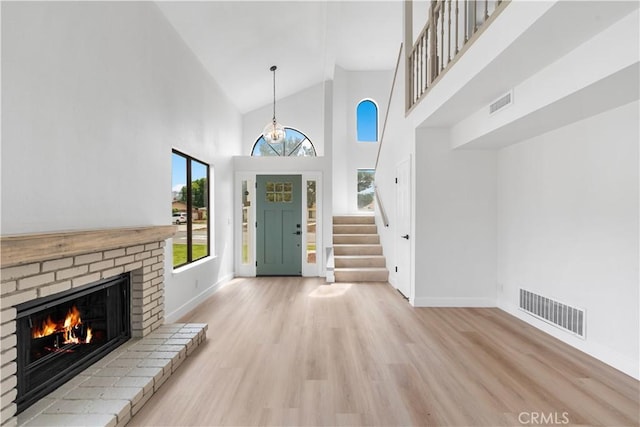 42346 W 47th St W, Lancaster, CA 93536 - entrance foyer featuring wood finished floors, high vaulted ceiling, baseboards, a fireplace, and stairs
