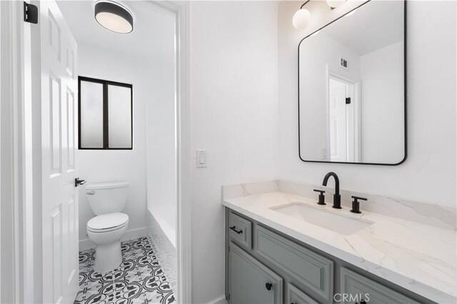 42346 W 47th St W, Lancaster, CA 93536 - bathroom with vanity, toilet, a bath, baseboards, and a shower