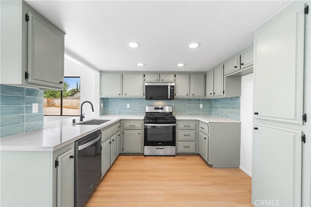42346 W 47th St W, Lancaster, CA 93536 - kitchen featuring stainless steel appliances, a sink, gray cabinets, backsplash, and recessed lighting
