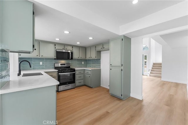 42346 W 47th St W, Lancaster, CA 93536 - kitchen featuring stainless steel appliances, a sink, light wood finished floors, decorative backsplash, and recessed lighting