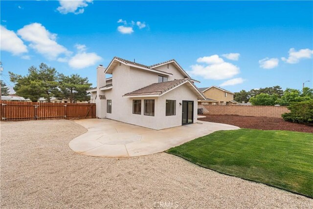 42346 W 47th St W, Lancaster, CA 93536 - back of property with stucco siding, a patio, a tiled roof, and a chimney