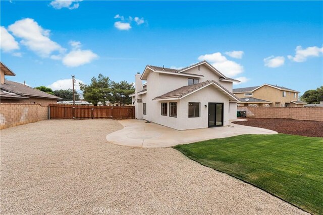 42346 W 47th St W, Lancaster, CA 93536 - back of property with stucco siding, a patio, a tiled roof, and a chimney