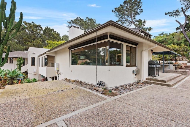 1859 Zapo St, Del Mar, CA 92014 - view of side of property with a patio, a chimney, and stucco siding
