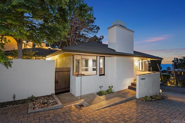 1859 Zapo St, Del Mar, CA 92014 - view of front of home featuring a gate, stucco siding, and a chimney