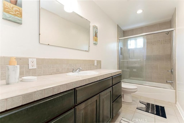 7129 Forbes Ave, Van Nuys, CA 91406 - bathroom with toilet, vanity, backsplash, tile patterned flooring, and combined bath / shower with glass door