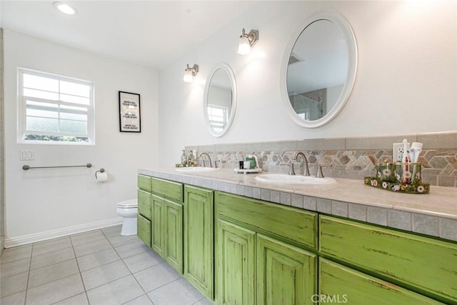 7129 Forbes Ave, Van Nuys, CA 91406 - bathroom with double vanity, toilet, tile patterned floors, and backsplash