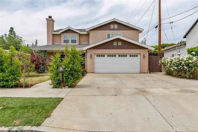 7129 Forbes Ave, Van Nuys, CA 91406 - view of front of house with stucco siding, a chimney, driveway, and a garage