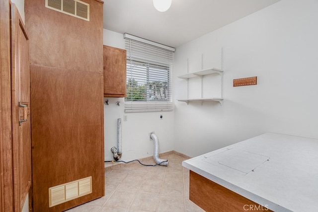 41202 Collegian Way, Hemet, CA 92544 - laundry area featuring electric dryer hookup and light tile patterned flooring