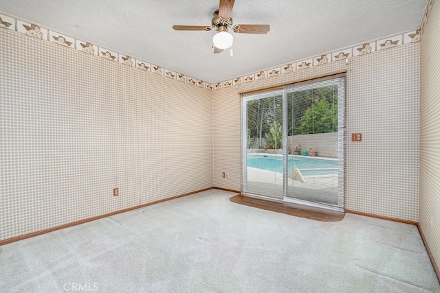 41202 Collegian Way, Hemet, CA 92544 - carpeted spare room featuring a textured ceiling, baseboards, wallpapered walls, and ceiling fan