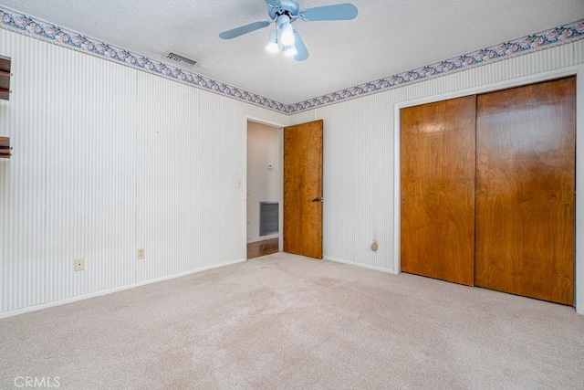41202 Collegian Way, Hemet, CA 92544 - unfurnished bedroom with a textured ceiling, a closet, carpet, a ceiling fan, and baseboards