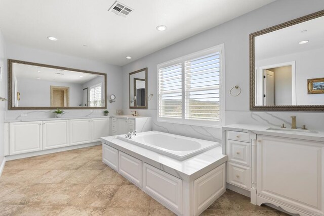 14220 Green Valley Ct, Scripps Miramar, CA 92131 - full bathroom with two vanities, a garden tub, and recessed lighting