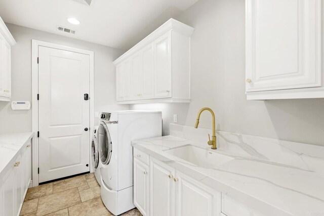 14220 Green Valley Ct, Scripps Miramar, CA 92131 - laundry room with cabinet space, independent washer and dryer, recessed lighting, and light stone finish flooring