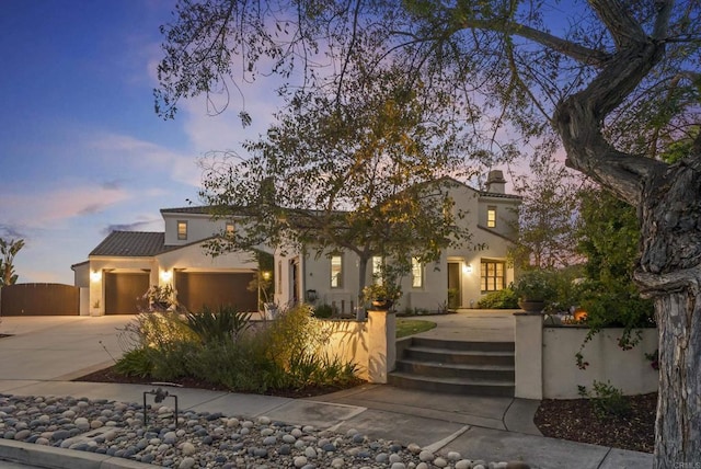 14220 Green Valley Ct, Scripps Miramar, CA 92131 - mediterranean / spanish-style home featuring concrete driveway, a fenced front yard, stucco siding, a garage, and a chimney