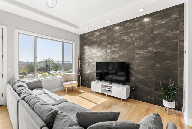 14220 Green Valley Ct, Scripps Miramar, CA 92131 - living area with recessed lighting, an accent wall, and wood finished floors