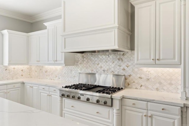 14220 Green Valley Ct, Scripps Miramar, CA 92131 - kitchen with stainless steel gas cooktop, premium range hood, white cabinetry, tasteful backsplash, and ornamental molding