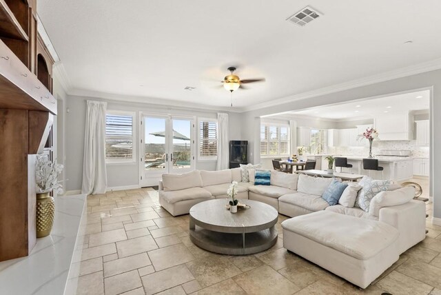 14220 Green Valley Ct, Scripps Miramar, CA 92131 - living room featuring crown molding, ceiling fan, and baseboards