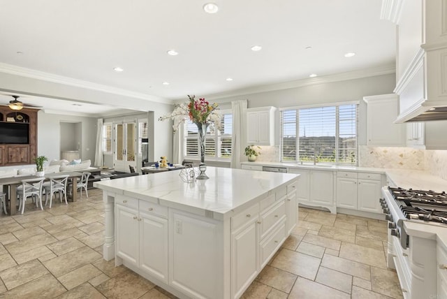14220 Green Valley Ct, Scripps Miramar, CA 92131 - kitchen featuring stainless steel appliances, stone tile floors, a kitchen island, decorative backsplash, and open floor plan
