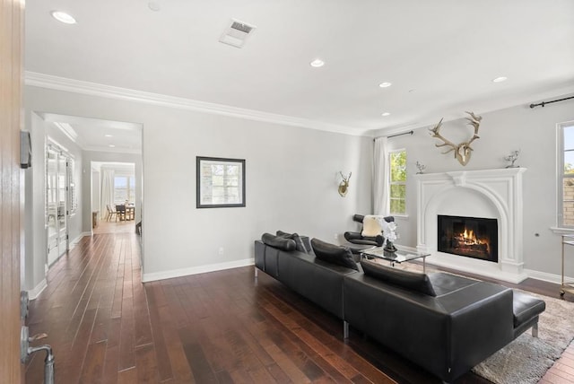 14220 Green Valley Ct, Scripps Miramar, CA 92131 - living room with dark wood-style flooring, a glass covered fireplace, recessed lighting, baseboards, and crown molding