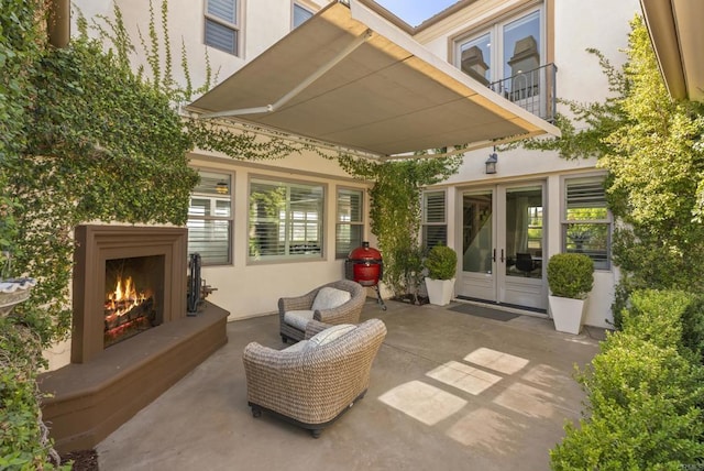 14220 Green Valley Ct, Scripps Miramar, CA 92131 - view of patio with a lit fireplace and french doors