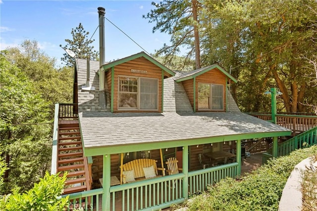 379 Dorn Dr, Crestline, CA 92325 - view of front of property featuring stairs, roof with shingles, log siding, and a wooden deck